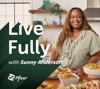 Smiling Sunny Anderson standing at a kitchen counter filled with food dishes, captioned Live Fully with Sunny Anderson